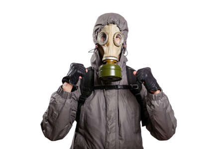An isolated shot of a man dressed in a gas mask, a jacket with a hood, a backpack, holds his fists in front of him with joy, luck of success, looks into the camera. On a white isolated background, the studioの写真素材
