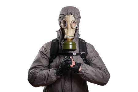 An isolated shot of a man dressed in a gas mask, a jacket with a hood, a backpack, holding his hands in front of him in the Asian greeting of the challenge to the fight, in respect for the enemy. On a white isolated background, the studioの写真素材