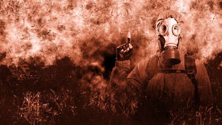 A shot of a man dressed in a gas mask, a jacket with a hood, a backpack, points his index finger up, looks into the camera. poster on the background of grungeの写真素材
