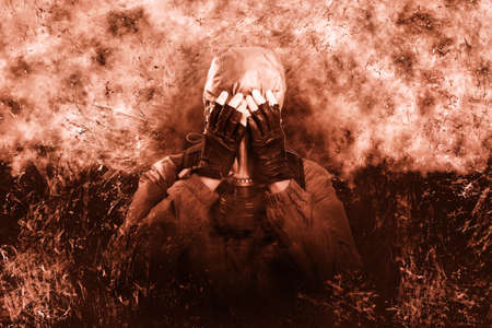 A shot of a man dressed in a gas mask, a jacket with a hood, a backpack, covered his face with his hands from dissuasion and trouble. poster on the background of grungeの写真素材