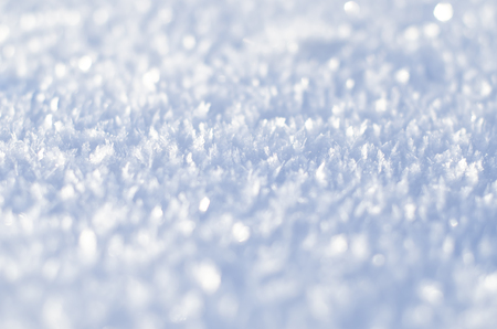 Snow texture with snowflakes close-up. Snow background for Christmas card or wallpaper. Blue macro image of an abstract snowdriftの写真素材
