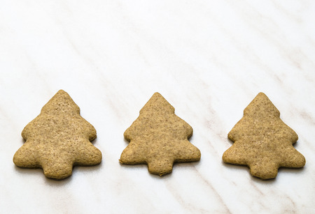 Home-baked gingerbread on a kitchen surface with a baking sheet and baking paper - Christmas concept with home-baked cookies in the kitchen.の写真素材