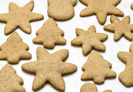 Home-baked gingerbread on a kitchen surface with a baking sheet and baking paper - Christmas concept with home-baked cookies in the kitchen.の写真素材
