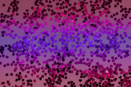 Holographic hearts on trendy pink, purple, red background. Festive backdrop. Top viewの写真素材