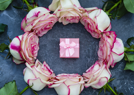 Roses on dark marble background with place for text. Gift box. Flat lay.の写真素材