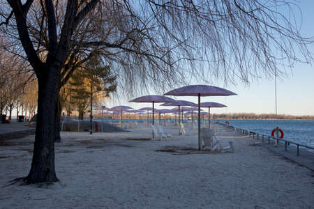 Beach chairs with umbrella in Lake Ontarioの写真素材