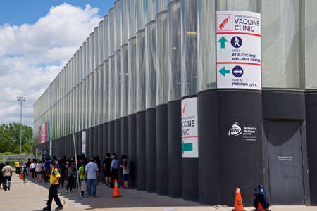Toronto, Ontario, Canada - June 14, 2021: Crowd of people line up at the exterior of the covid-19 vaccine clinic in Toronto, Canada.のeditorial素材