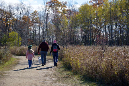 Toronto, Ontario / Canada - October 31, 2020: Family hiking in the forest footpath with social distancing.のeditorial素材