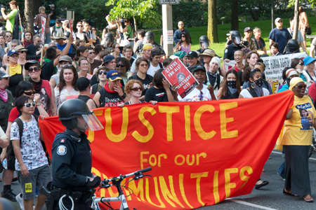 Toronto, Ontario, Canada - 06/25/2010: Crowd of multi-ethnic men and woman walking on street protest...