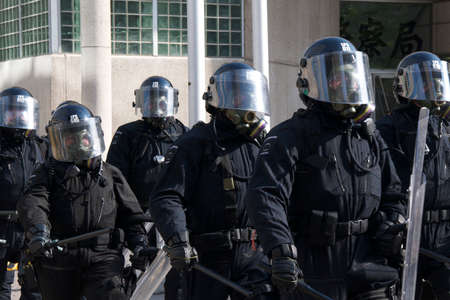 Toronto, Ontario, Canada - 06/25/2010 : Riot police in full gear to control thousands of activists marching in a protest ahead of the G20 summitのeditorial素材