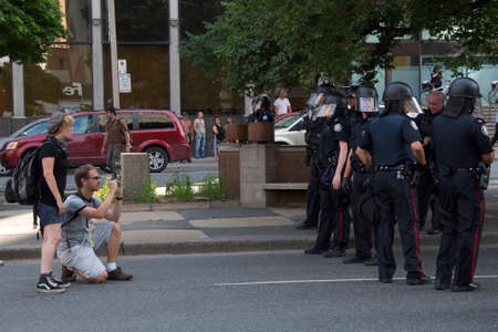 Toronto, Ontario, Canada - 25th June 2010: Rioter confronting the riot policies in a protest ahead...