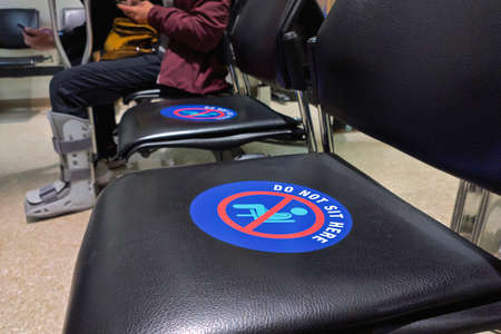 Toronto, Ontario, Canada - 11/18/2021: Social distance concept. keep spaced between each chairs make separate for social distancing ( indoor at the Fracture Clinic ), increasing physical space between people to avoid spreading illness during transmission のeditorial素材