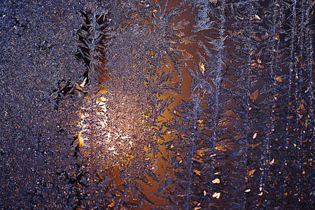 Frozen drops of condensed steam water drops on the transparent window glass. Clean blue background. Condensation of moisture at extreme temperatures. Beautiful nature texture.の写真素材