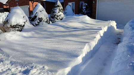 The driveway is covered with deep white snow in Canada for a weather or blizzard concept.の写真素材