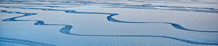 Bluewater surface texture with melting ice and ripples.  Abstract winter banner background Water...