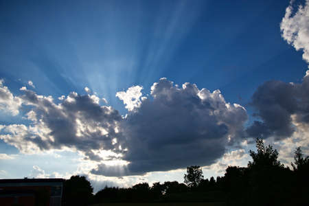 Sun rays with the blue cloudy sky in the background