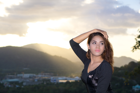 Bell portrait shooting in Rang Hill, Phuket, Thailand. She was capture with sunset background. This is a famous place sunset view point in Phuket city.の写真素材