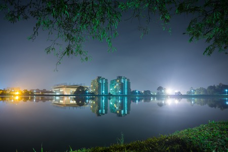 Glittering light illuminated the night, lake surface reflected the light, gentle breeze blew over, the view was spectacular. This is a water storage for Songkra University, Thailand, countless stunning vistas along the way. Casual rambles loop around, it のeditorial素材