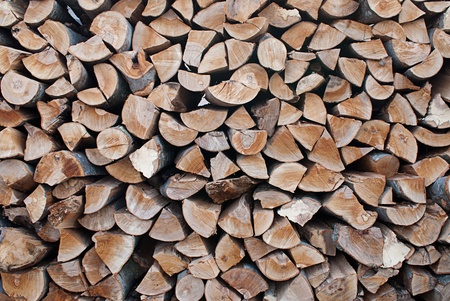 The section of the firewood logs stacked up on top of each other in a pile 