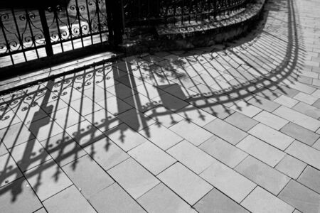 Wrought iron fence and shadow - abstract photographyの写真素材
