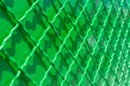 Green metal reconditioned fence. Background with selective focusの写真素材