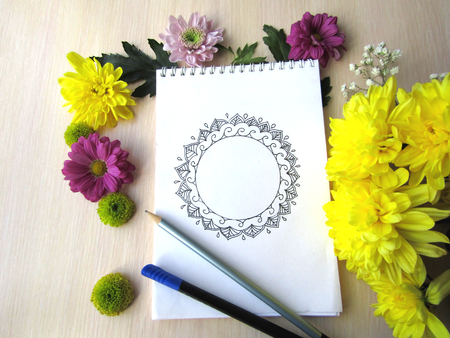 Notebook is open for inscription with yellow flowersの写真素材