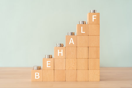 Wooden blocks with "BEHALF" text of concept and coins.の写真素材