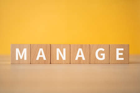 Wooden blocks with "MANAGE" text of concept.の写真素材