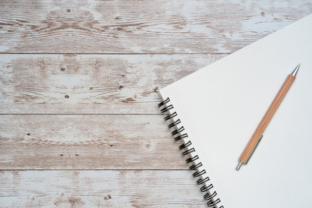 Blank notebook with pencil on wooden table. Top view with copy spaceの写真素材