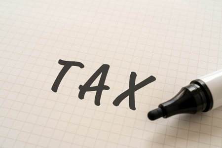 White paper written "TAX" with a marker.の写真素材
