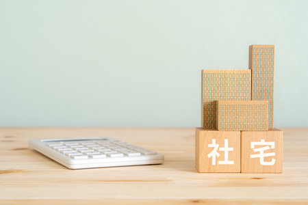 Wooden blocks with chinese hieroglyphs and calculator on wooden tableの写真素材