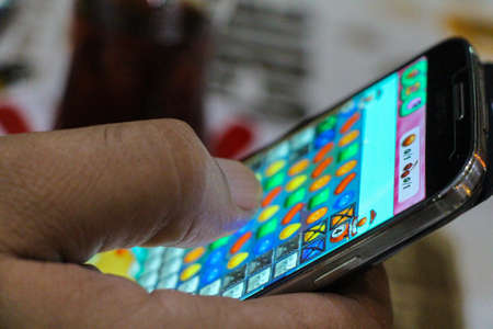 Playing Candy crash. Candy Crash game.のeditorial素材