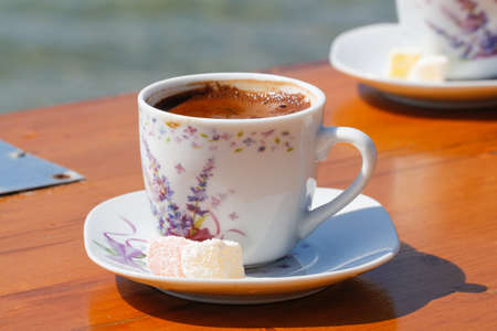 Turkish coffee and delight. Coffee cup on the beach.の写真素材