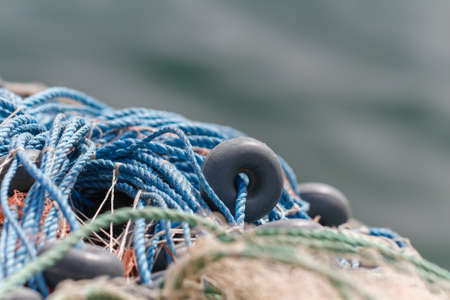 Fishing nets closeup. Background of fishing nets and floats. Fishing nets with sea background.の写真素材