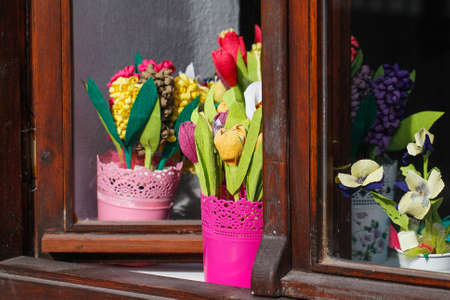 Flowers in pots. Flowers of handicraft papyrus. Colorful flowers in window.の写真素材