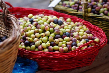Basket with olives. Freshly harvested green and black olives.の写真素材