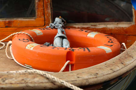 Orange lifebuoy in the boat. Boat and ship equipment.