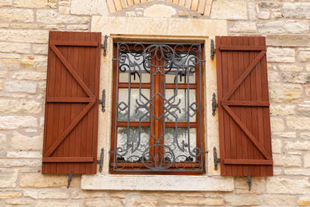 Window.old barred windows ornamented with metal lattice.の写真素材
