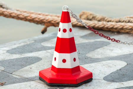 Road traffic cone pylon. Signal cone. Traffic barrier at the port.の写真素材