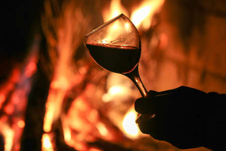 Drink wine in front of the fireplace.の写真素材