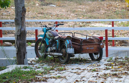 Old vintage rusty motorcycles in field close up. Antique.