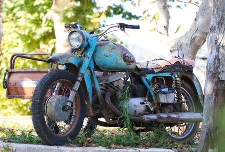 Old vintage rusty motorcycles in field close up. Antique.の写真素材