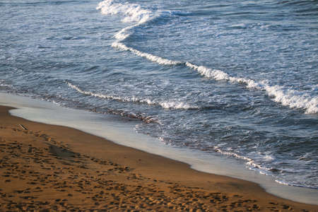 Clear blue sea water with waves and beach.の写真素材