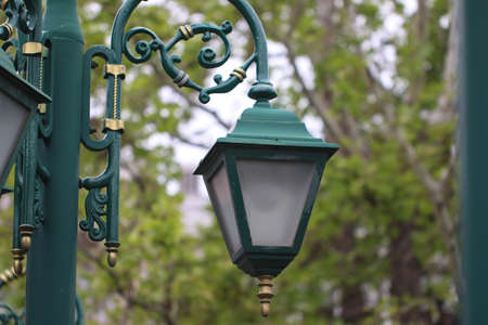 Old style green street lantern in city park.の写真素材