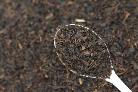 Dry black tea on a spoon.の写真素材