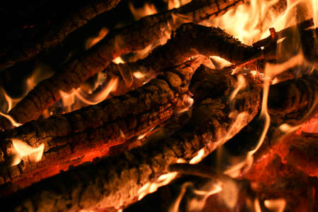 Closeup of a large fire. Wooden planks to the fire. The fire is lit in the night.の写真素材
