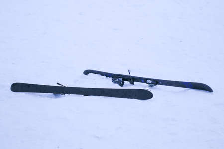 Wood in metal brazier. Places are covered with snow.の写真素材