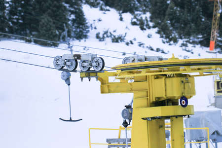 Mechanism of transportation cable lift on the snow mountain. Uludag is the ancient Mysian Olympus and Bithynian Olympus, a mountain in Bursa Province, Turkey. Ski lifts durings bright winter day.の写真素材