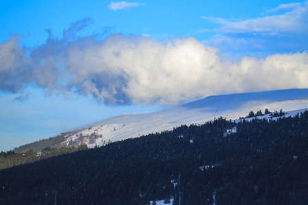Winter landscape with snow mountain range and blue sky.の写真素材