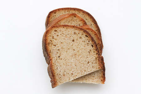 Sour yeast bread slices. Tradtional homemade bread on white background.の写真素材